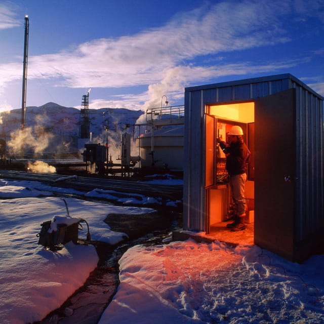 Engineer working in a shed in a cold climate