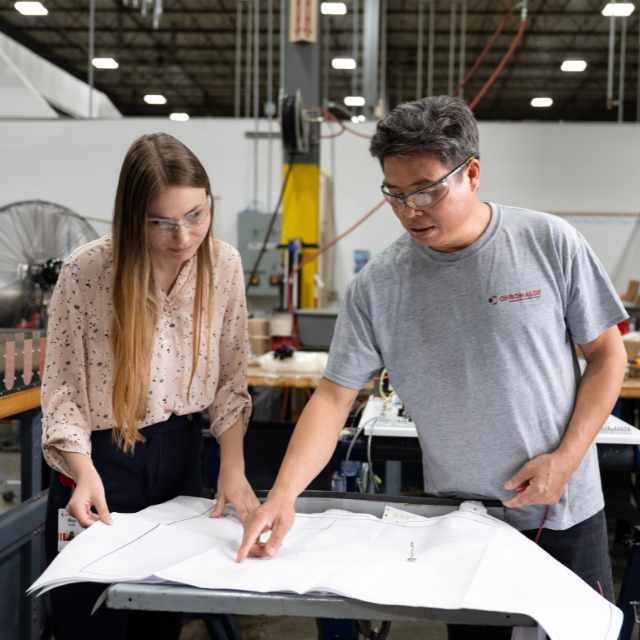 Picture of two chromalox people looking at a paper