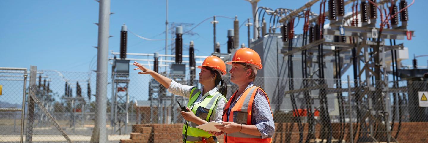 Engineers on site near electrical unit