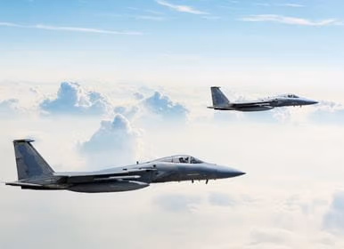 Two jet engines flying in the sky