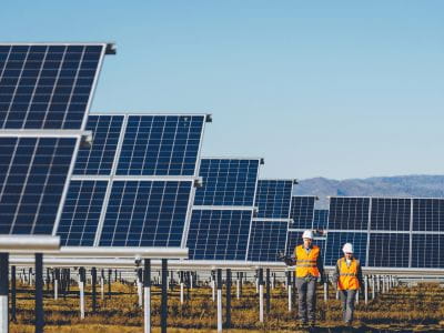 Two engineers walking through a solar field