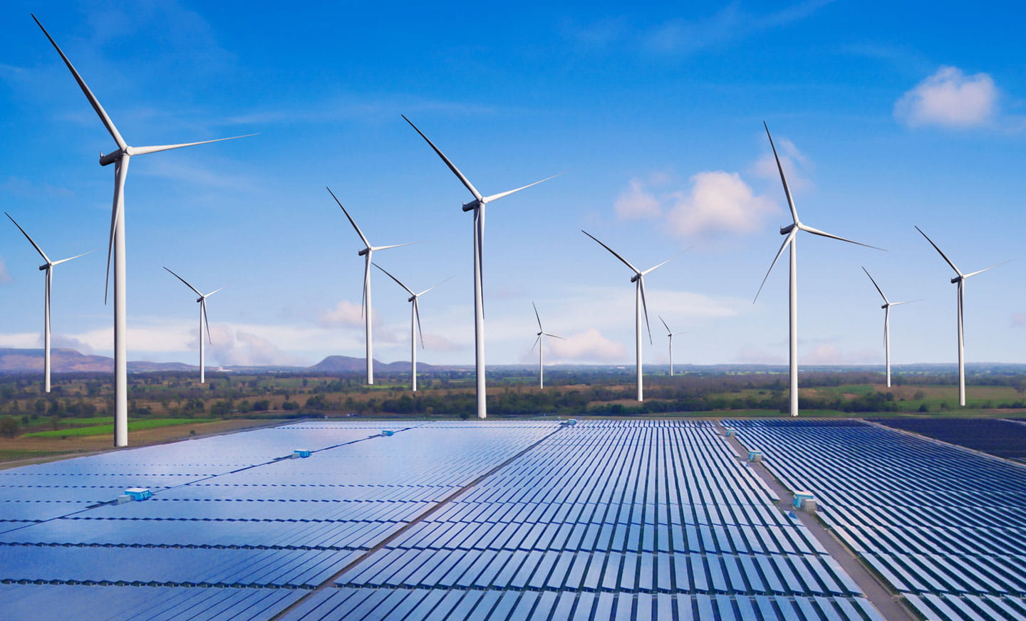 Energy sector image including solar panels and wind turbines