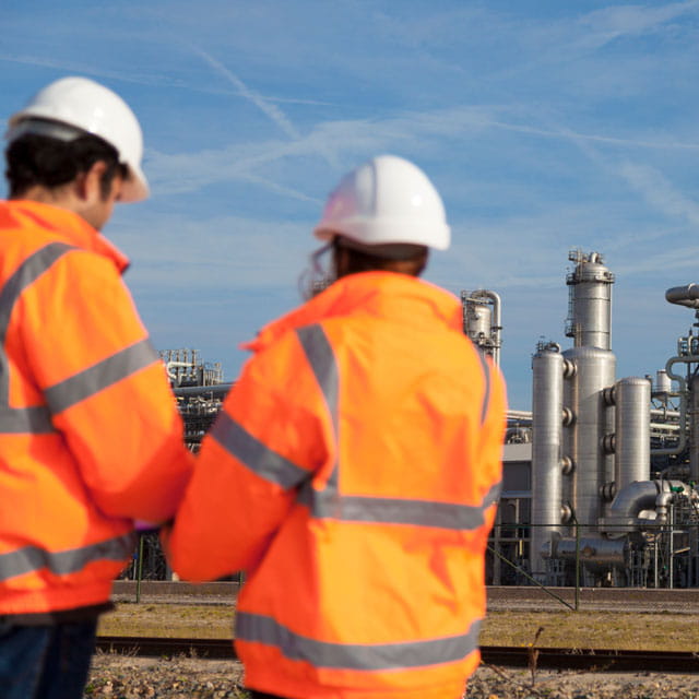 Two engineers looking at an industrial plant