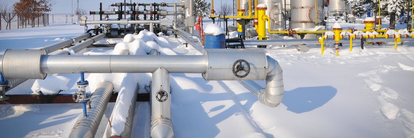 Picture of industrial pipes in winter with snow