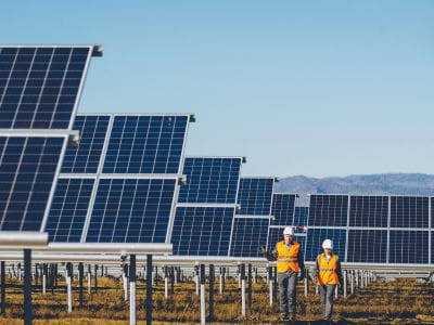 Solar panels with two engineers walking