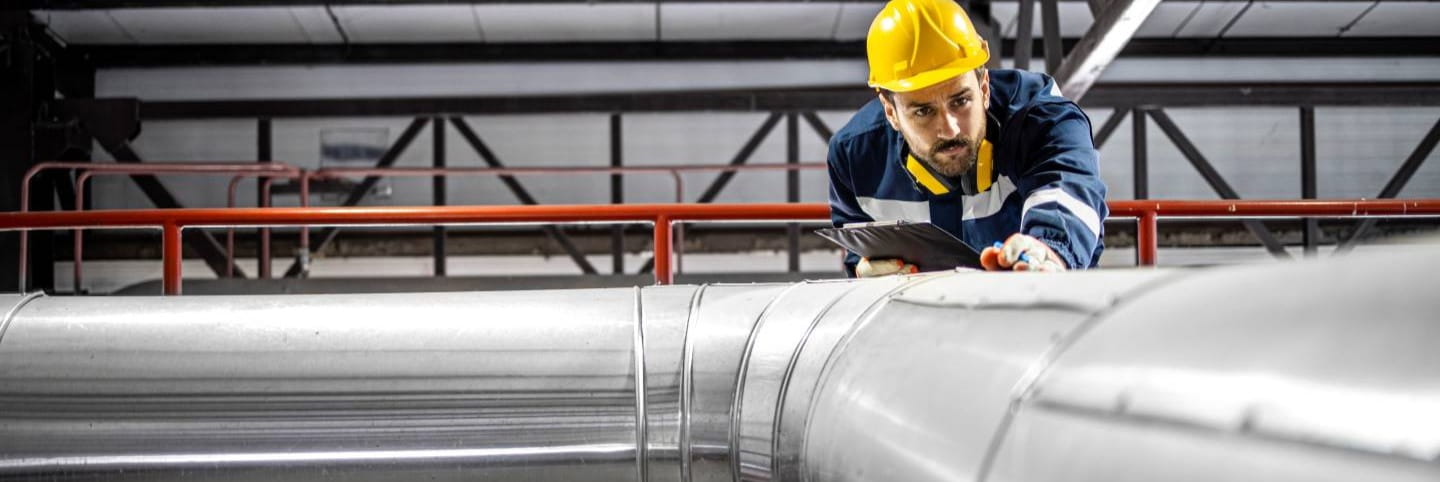 Engineer examining pipes for heat tracing