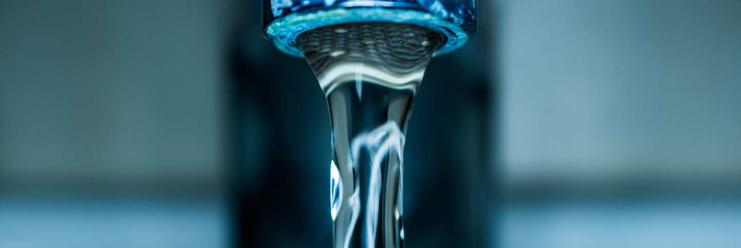 Drinking water pouring from a tap