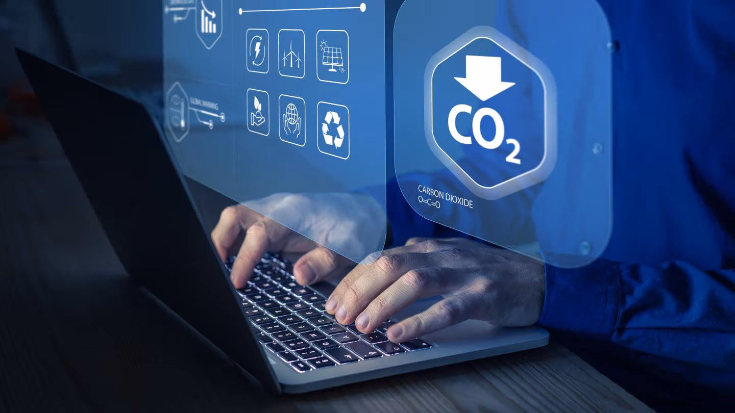 Someone typing at a laptop about carbon reduction